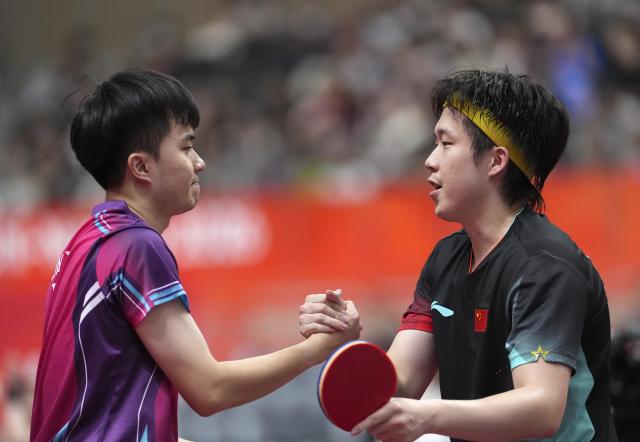 (260923) -- TOYOTA, Sept. 23, 2026 (Xinhua) -- Wang Chuqin (R) of China shakes hands with Lin Yun-ju of Chinese Taipei during the men's team semifinal match between China and Chinese Taipei at the 20th Asian Games Aichi-Nagoya 2026 in Toyota of Aichi Prefecture, Japan, Sept. 23, 2026. (Xinhua/Cheong Kam Ka)
