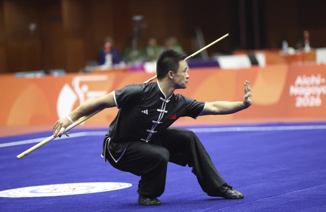 (260923) -- NAGOYA, Sept. 23, 2026 (Xinhua) -- Gao Xiaobin of China competes during the Gunshu round of the Men's Daoshu and Gunshu Final of Wushu at the 20th Asian Games Aichi-Nagoya 2026 in Nagoya, Japan, Sept. 23, 2026. (Xinhua/Long Lei)
