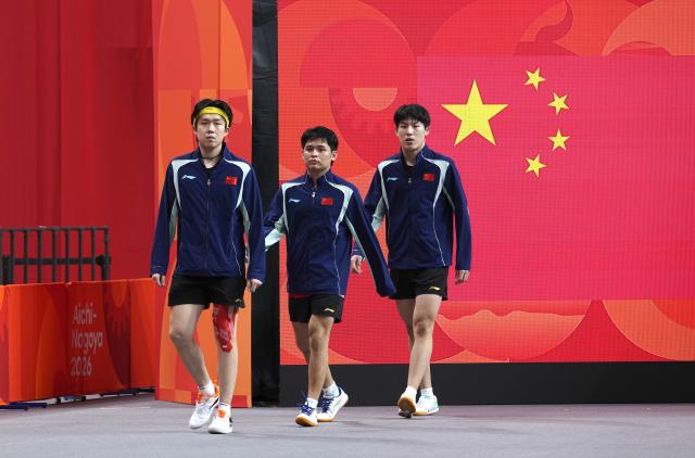 (260923) -- TOYOTA, Sept. 23, 2026 (Xinhua) -- Wang Chuqin, Lin Shidong and Wen Ruibo (L to R) of China enter the arena before the men's team semifinal match between China and Chinese Taipei at the 20th Asian Games Aichi-Nagoya 2026 in Toyota of Aichi Prefecture, Japan, Sept. 23, 2026. (Xinhua/Cheong Kam Ka)