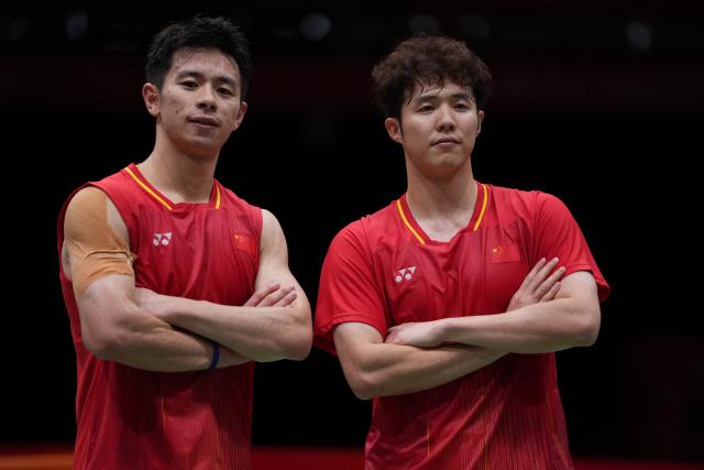 (260923) -- ICHINOMIYA, Sept. 23, 2026 (Xinhua) -- He Jiting (R)/Liu Yi of China celebrate after the men's team semifinal match of badminton between China and India at the 20th Asian Games Aichi-Nagoya 2026 in Ichinomiya of Aichi Prefecture, Japan, Sept. 23, 2026. (Xinhua/Li Bo)