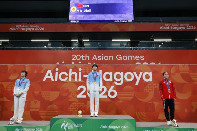 (260923) -- TOKYO, Sept. 23, 2026 (Xinhua) -- Gold medalist Yu Zidi (C) of China, Silver medalist Ke Wenxi (L) of China and Bronze medalist Narita Mio of Japan pose during the awarding ceremony after the women's 400m individual medley final at the 20th Asian Games Aichi-Nagoya 2026 in Tokyo, Japan, Sept. 23, 2026. (Xinhua/Wu Zhizun)