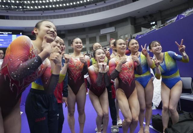 (260923) -- NAGOYA, Sept. 23, 2026 (Xinhua) -- Team China (L) and team Japan pose for group photos after the women's team final of Artistic Gymnastics at the 20th Asian Games Aichi-Nagoya 2026 in Nagoya, Japan, Sept. 23, 2026. (Xinhua/Lui Siu Wai)