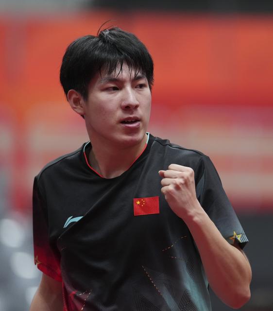 (260923) -- TOYOTA, Sept. 23, 2026 (Xinhua) -- Wen Ruibo of China celebrates against Kuo Guan-hong of Chinese Taipei during the men's team semifinal match between China and Chinese Taipei at the 20th Asian Games Aichi-Nagoya 2026 in Toyota of Aichi Prefecture, Japan, Sept. 23, 2026. (Xinhua/Cheong Kam Ka)
