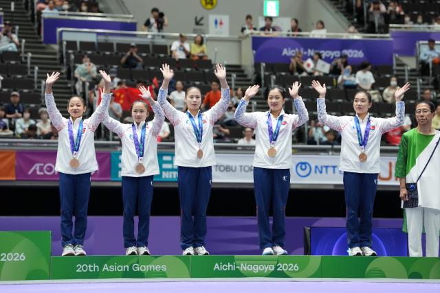 (260923) -- NAGOYA, Sept. 23, 2026 (Xinhua) -- Bronze medalists of team DPRK (Democratic People's Republic of Korea) pose on the podium during the awarding ceremony of the women's team final of Artistic Gymnastics at the 20th Asian Games Aichi-Nagoya 2026 in Nagoya, Japan, Sept. 23, 2026. (Xinhua/Lui Siu Wai)
