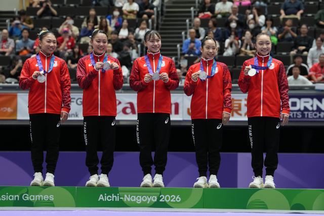 (260923) -- NAGOYA, Sept. 23, 2026 (Xinhua) -- Silver medalists team Japan pose on the podium during the awarding ceremony for the women's team final of Artistic Gymnastics at the 20th Asian Games Aichi-Nagoya 2026 in Nagoya, Japan, Sept. 23, 2026. (Xinhua/Lui Siu Wai)