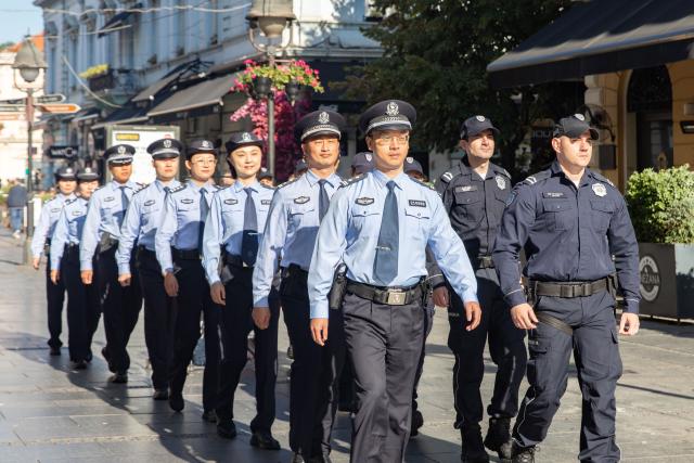 (260924) -- BELGRADE, Sept. 24, 2026 (Xinhua) -- Chinese and Serbian police officers conduct a joint patrol on a street in Belgrade, Serbia, Sept. 23, 2026. Chinese and Serbian police officers launched a three-week joint patrol program in downtown Belgrade on Wednesday, aiming at assisting Chinese tourists and residents and strengthening bilateral law enforcement cooperation. (Photo by Wang Wei/Xinhua)