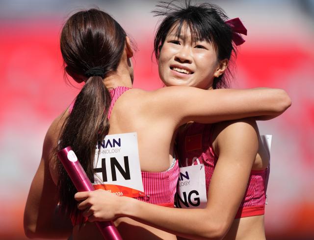 (260924) -- NAGOYA, Sept. 24, 2026 (Xinhua) -- Jiang Yutong (R) and Kong Yingying of China hug after the mixed 4X400m relay heats of Athletics at the 20th Asian Games Aichi-Nagoya 2026 in Nagoya, Japan, Sept. 24, 2026. (Xinhua/Lui Siu Wai)