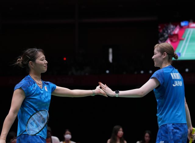 (260924) -- ICHINOMIYA, Sept. 24, 2026 (Xinhua) -- Fukushima Yuki (L)/Matsumoto Mayu of team Japan react during the doubles match against Liu Shengshu/Tan Ning of team China of the badminton women's team final between China and Japan at the 20th Asian Games Aichi-Nagoya 2026 in Ichinomiya of Aichi Prefecture, Japan, Sept. 24, 2026. (Xinhua/Hou Zhaokang)