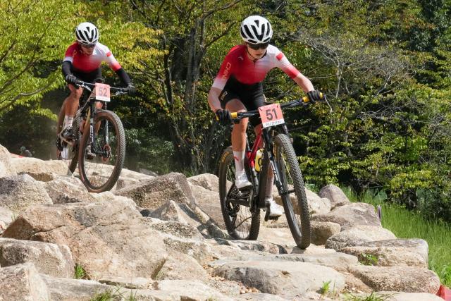 (260924) -- NAGOYA, Sept. 24, 2026 (Xinhua) -- Wu Zhifan (R) and Liang Zhenglan of China compete during the women's cross-country final of cycling mountain bike at the 20th Asian Games Aichi-Nagoya 2026 in Nagoya, Japan, Sept. 24, 2026. (Xinhua/Cen Yunpeng)