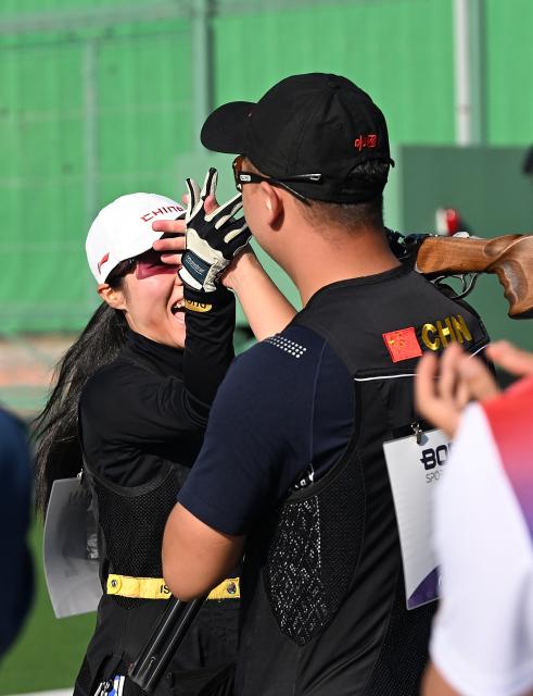 (260924) -- TOYOTA, Sept. 24, 2026 (Xinhua) -- Lyu Jianlin (R) and Jiang Yiting of team China celebrate after the Skeet mixed team final of Shooting at the 20th Asian Games Aichi-Nagoya 2026 in Toyota of Aichi Prefecture, Japan, Sept. 24, 2026. (Xinhua/Liu Lei)