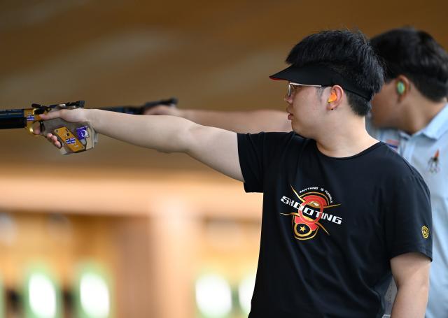 (260924) -- TOYOTA, Sept. 24, 2026 (Xinhua) -- Hu Kai (L) of team China competes during the 10m Air Pistol men team final of Shooting at the 20th Asian Games Aichi-Nagoya 2026 in Toyota of Aichi Prefecture, Japan, Sept. 24, 2026. (Xinhua/Liu Lei)
