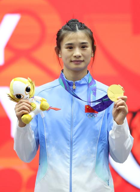 (260924) -- NAGOYA, Sept. 24, 2026 (Xinhua) -- Gold medalist Wu Di of China poses during the victory ceremony for the women's 52kg of Wushu at the 20th Asian Games Aichi-Nagoya 2026 in Nagoya, Japan, Sept. 24, 2026. (Xinhua/Long Lei)