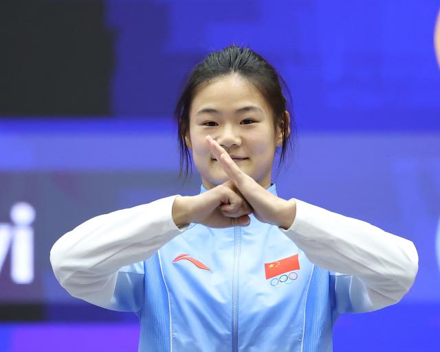 (260924) -- NAGOYA, Sept. 24, 2026 (Xinhua) -- Gold medalist Zhang Xiaoyu of China poses during the victory ceremony for the women's 60kg of Wushu at the 20th Asian Games Aichi-Nagoya 2026 in Nagoya, Japan, Sept. 24, 2026. (Xinhua/Long Lei)
