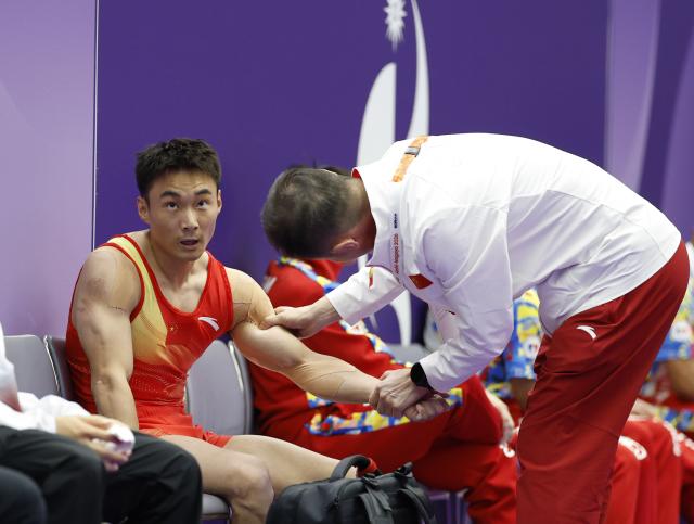(260924) -- NAGOYA, Sept. 24, 2026 (Xinhua) -- Sun Wei (L) of China reacts during the men's floor exercise final of Artistic Gymnastics at the 20th Asian Games Aichi-Nagoya 2026 in Nagoya, Japan, Sept. 24, 2026. (Xinhua/Wang Lili)