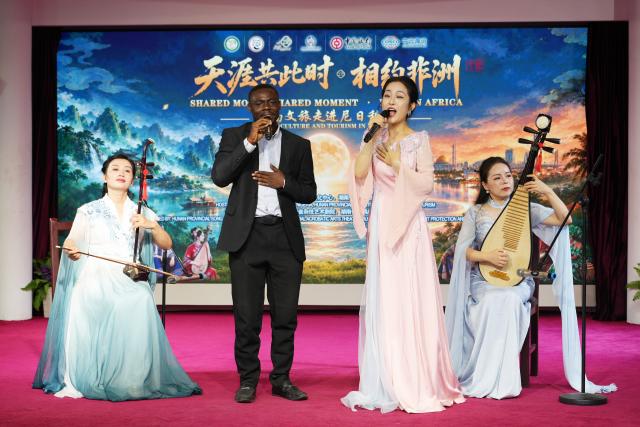 (260924) -- ABUJA, Sept. 24, 2026 (Xinhua) -- Chinese and Nigerian artists perform songs together on stage to celebrate the upcoming Mid-Autumn Festival in Abuja, Nigeria, Sept. 24, 2026. (Photo by Amzat Adewale/Xinhua)