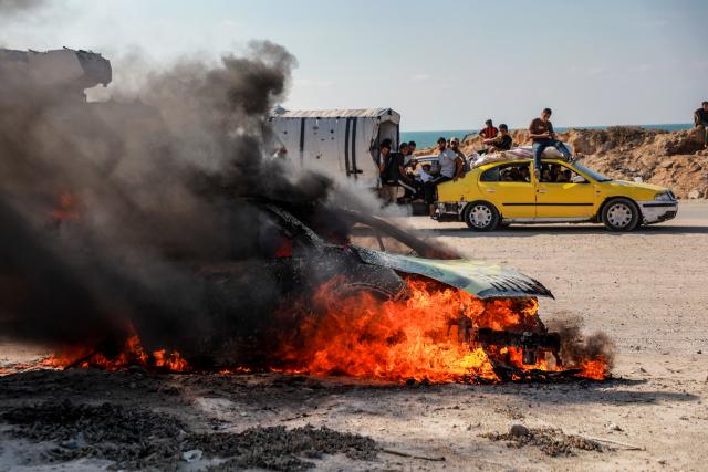 (260924) -- GAZA, Sept. 24, 2026 (Xinhua) -- Smoke and fire rise from a burned vehicle following an Israeli drone strike in Gaza City, Sept. 24, 2026. (Photo by Rizek Abdeljawad/Xinhua)