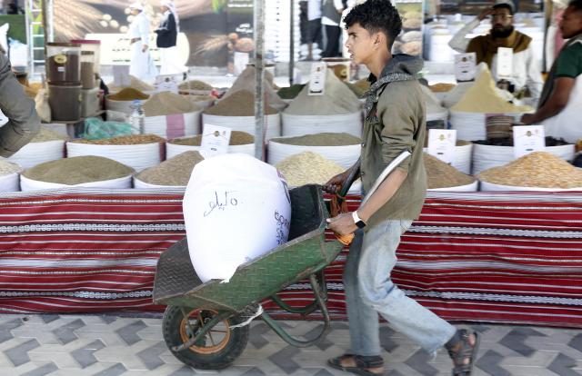 (260924) -- SANAA, Sept. 24, 2026 (Xinhua) -- A boy pushes a wheelbarrow carrying a bag of local grains he bought from a fair in Sanaa, Yemen, Sept. 24, 2026. A fair named The Fertile Land promoting local grain products was launched in Sanaa recently to foster a culture of reliance on national goods and boost domestic agricultural marketing. (Photo by Mohammed Mohammed/Xinhua)