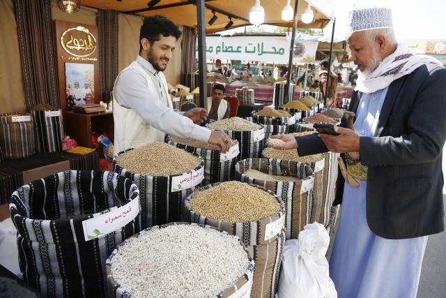 (260924) -- SANAA, Sept. 24, 2026 (Xinhua) -- A customer checks the quality of local grains during a fair in Sanaa, Yemen, Sept. 24, 2026. A fair named The Fertile Land promoting local grain products was launched in Sanaa recently to foster a culture of reliance on national goods and boost domestic agricultural marketing. (Photo by Mohammed Mohammed/Xinhua)