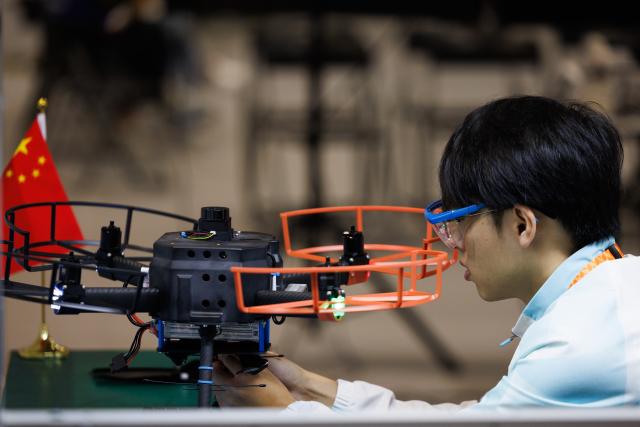 (260925) -- SHANGHAI, Sept. 25, 2026 (Xinhua) -- A contestant participates in the unmanned aerial systems event during the 48th WorldSkills Competition in Shanghai, east China, Sept. 25, 2026.
  The 48th WorldSkills Competition is held in Shanghai from September 22 to 27. 
  Various events in the competition are related in the maintenance of equipment and facilities in the air, on land and on rails. (Xinhua/Jin Liwang)