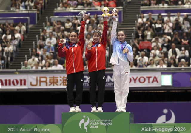(260925) -- NAGOYA, Sept. 25, 2026 (Xinhua) -- Gold medalist Sugihara Aiko (C) of Japan, silver medalist Nishiyama Misa (L) of Japan and bronze medalist Zhang Yihan of China pose during the awarding ceremony after the women's floor exercise final of Artistic Gymnastics at the 20th Asian Games Aichi-Nagoya 2026 in Nagoya, Japan, Sept. 25, 2026. (Xinhua/Xu Yanan)