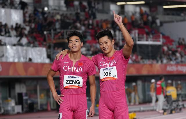 (260925) -- NAGOYA, Sept. 25, 2026 (Xinhua) -- Xie Zhenye (R) and Zeng Keli of China react after the men's 100m final of Athletics at the 20th Asian Games Aichi-Nagoya 2026 in Nagoya, Japan, Sept. 25, 2026. (Xinhua/Jia Yuchen)