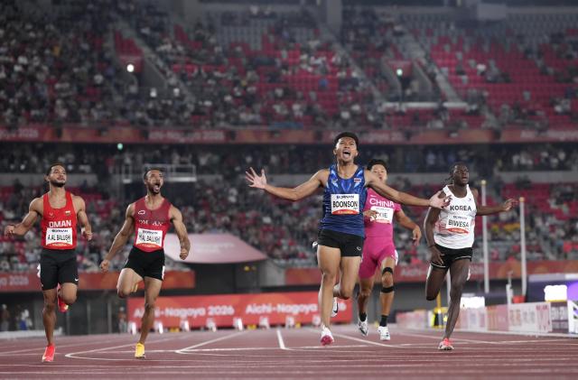 (260925) -- NAGOYA, Sept. 25, 2026 (Xinhua) -- Boonson Puripol (C) of Thailand celebrates after winning the men's 100m final of Athletics at the 20th Asian Games Aichi-Nagoya 2026 in Nagoya, Japan, Sept. 25, 2026. (Xinhua/Lui Siu Wai)