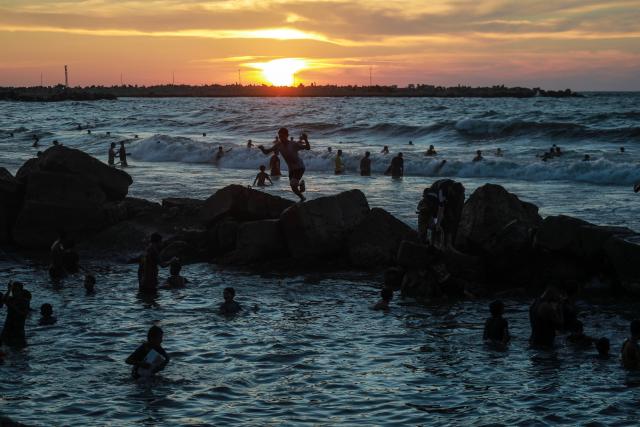 (260925) -- GAZA, Sept. 25, 2026 (Xinhua) -- Palestinians spend time on a beach west of Gaza City, Sept. 25, 2026. (Photo by Rizek Abdeljawad/Xinhua)