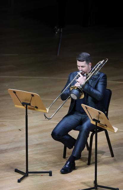 (260926) -- TIANJIN, Sept. 26, 2026 (Xinhua) -- Lee Allen plays the trombone in a brass quintet performance at the Tianjin Juilliard School in Tianjin, north China, Sept. 18, 2026.
  Lee Allen, a U.S. trombonist, joined the Tianjin Juilliard School as one of its first resident faculty members in 2019. 
  In 2017, while still teaching in the U.S. state of Ohio, Allen led five students on a month-long tour across China, covering 17 cities and staging 19 concerts. This immersive experience gave him deep insight into China's thriving artistic landscape. He noted that the abundance of opportunities, strong institutional support for the arts, and Tianjin's livable urban environment convinced him to build his long-term career here. 
  Over the years, Allen has dedicated himself to nurturing young musical talent, with generations of his students going on to perform on leading international stages. His two children were both born and raised in Tianjin, making the city a true family home. 
  This year, the Tianjin Juilliard School formed its first all-faculty brass quintet, a rare opportunity that allows Allen to perform alongside his peers and deepen his artistic practice. 
  For Allen, music bridges different civilizations, and the Tianjin Juilliard School is a dynamic platform for exchange between Chinese and U.S. arts education. "Teaching is a two-way journey of growth," he said. "While I guide my students, they also teach me every day." (Xinhua/Sun Fanyue)