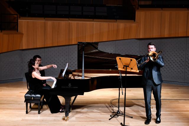 (260926) -- TIANJIN, Sept. 26, 2026 (Xinhua) -- This undated file photo shows Lee Allen (R) playing the trombone at the Tianjin Juilliard School in Tianjin, north China.
  Lee Allen, a U.S. trombonist, joined the Tianjin Juilliard School as one of its first resident faculty members in 2019. 
  In 2017, while still teaching in the U.S. state of Ohio, Allen led five students on a month-long tour across China, covering 17 cities and staging 19 concerts. This immersive experience gave him deep insight into China's thriving artistic landscape. He noted that the abundance of opportunities, strong institutional support for the arts, and Tianjin's livable urban environment convinced him to build his long-term career here. 
  Over the years, Allen has dedicated himself to nurturing young musical talent, with generations of his students going on to perform on leading international stages. His two children were both born and raised in Tianjin, making the city a true family home. 
  This year, the Tianjin Juilliard School formed its first all-faculty brass quintet, a rare opportunity that allows Allen to perform alongside his peers and deepen his artistic practice. 
  For Allen, music bridges different civilizations, and the Tianjin Juilliard School is a dynamic platform for exchange between Chinese and U.S. arts education. "Teaching is a two-way journey of growth," he said. "While I guide my students, they also teach me every day." (Xinhua)