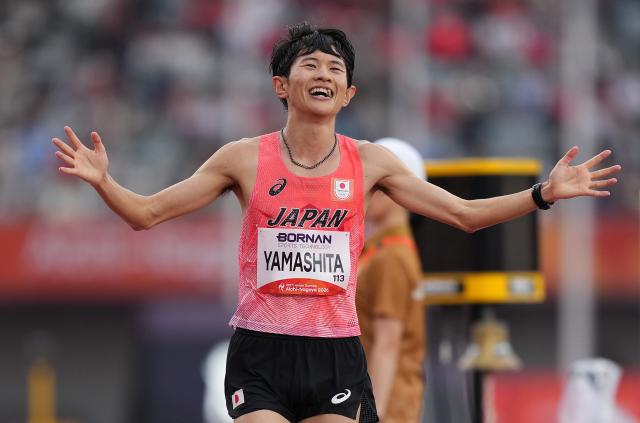 (260926) -- NAGOYA, Sept. 26, 2026 (Xinhua) -- Yamashita Ichitaka of Japan celebrates as he crosses the finish line during the men's marathon final of Athletics at the 20th Asian Games Aichi-Nagoya 2026 in Nagoya, Japan, Sept. 26, 2026. (Xinhua/Lui Siu Wai)