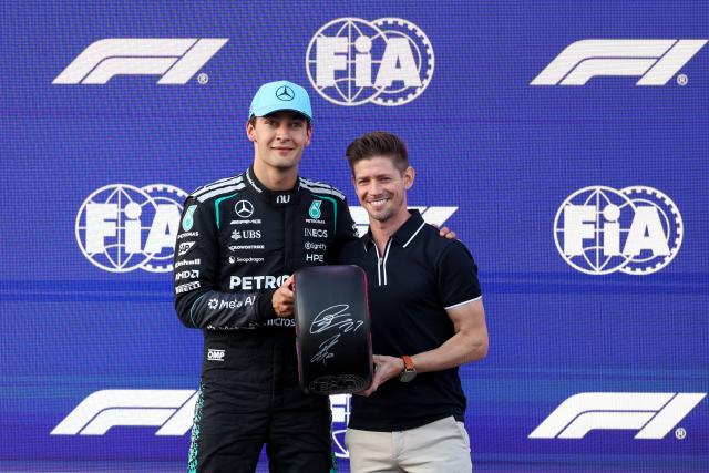 (260926) -- BAKU, Sept. 26, 2026 (Xinhua) -- Pole position qualifier Mercedes' driver George Russell (L) of Britain receives his pole position award from 2-time FIM MotoGP world champion Casey Stoner of Australia after the qualifying session of the Formula One Azerbaijan Grand Prix at the Baku City Circuit in Baku, Azerbaijan, Sept. 25, 2026. (Photo by Qian Jun/Xinhua)