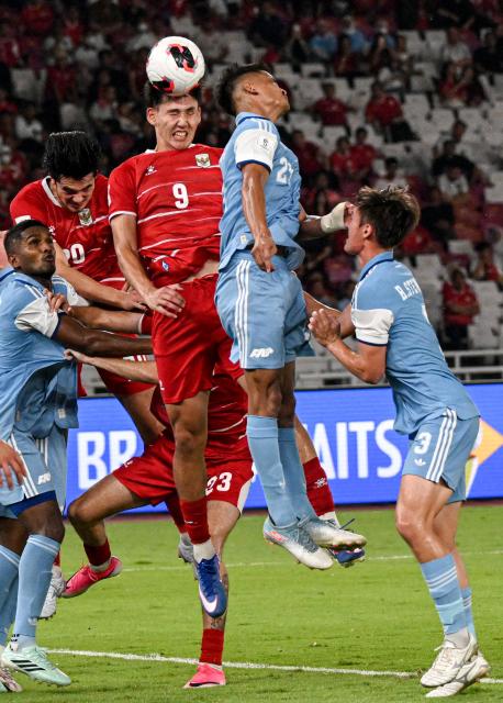 (260926) -- JAKARTA, Sept. 26, 2026 (Xinhua) -- Mitchell Lee Baker (3rd R) of Indonesia heads the ball during the FIFA ASEAN Cup 2026 Division 1 Group A match 
between Indonesia and Singapore at Gelora Bung Karno Stadium, Jakarta, Indonesia, Sept. 25, 2026. (Xinhua/Agung Kuncahya B.)