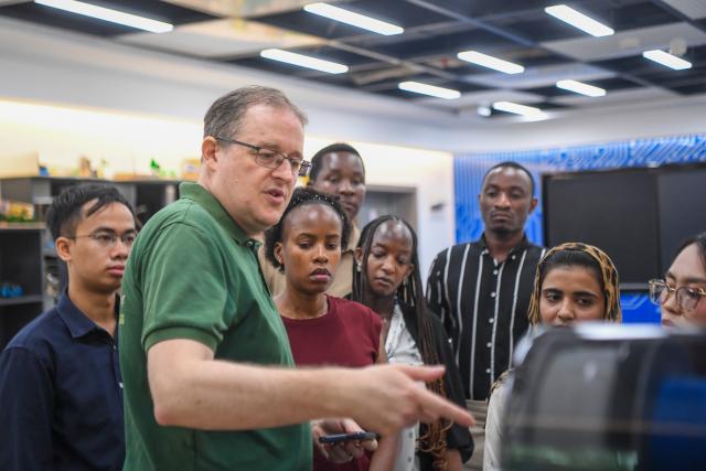 (260927) -- CHONGQING, Sept. 27, 2026 (Xinhua) -- Francis Stonier (front) gives a lesson using 3D printing at a lab of the STEAM Interdisciplinary International Education Center in Southwest University in southwest China's Chongqing Municipality, Sept. 14, 2026.
  Since arriving in Chongqing in 2019 to take up a teaching post, U.S. scholar Francis Stonier has become a well-known local figure. Over the past few years, he has devoted himself to promoting STEAM (Science, Technology, Engineering, Arts, Mathematics) interdisciplinary education and free science outreach for rural school students.
  Currently a professor at Southwest University, Stonier teaches academic writing to international students. Beyond his university lectures, Stonier brings science to life for primary and secondary school students. He simplifies complex concepts, tailoring them for young children. 
  To make science more accessible, Stonier has developed personalized STEAM curricula. Using 3D printing and LEGO bricks, he transforms complex academic concepts into hands-on experiments, encouraging students to explore science through creation and teamwork. In a creative lesson at Bashu Primary School in Chongqing, Stonier used everyday items to simulate birds' foraging behaviors, helping kids understand natural science through play. 
  Since 2019, Stonier has visited nearly 80 primary and secondary schools across Chongqing, including those in remote rural areas, to give free science lessons. 
  Stonier's grassroots teaching experience has also reshaped his understanding of education. He speaks highly of Chinese educators' openness to practical and innovative teaching approaches. 
  Stonier has witnessed Chongqing's development. He has fully immersed himself in local life. Moved by the warmth of the Chongqing people, and the city's unique charm and diverse cuisine, Stonier regards Chongqing as his second hometown, praising its harmonious balance of urban convenience and natural scenery. (Xinhua/Tang Yi)