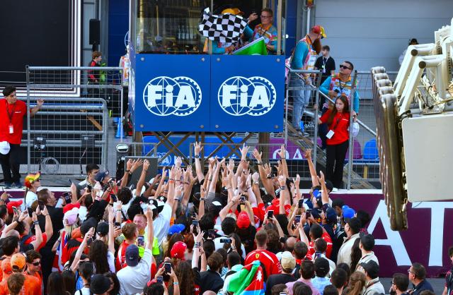 (260927) -- BAKU, Sept. 27, 2026 (Xinhua) -- Fans celebrate on the track after the Formula One Azerbaijan Grand Prix at the Baku City Circuit in Baku, on Sept. 26, 2026. (Xinhua/Chen Junfeng)