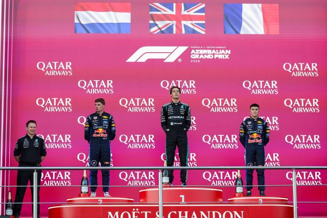 (260927) -- BAKU, Sept. 27, 2026 (Xinhua) -- Winner Mercedes' driver George Russell of Britain (2nd R), 2nd placed Red Bull Racing's driver Max Verstappen of the Netherlands (2nd L), 3rd placed driver Red Bull Racing's Isack Hadjar (1st R) of France and Mercedes's team representative Trackside Control Systems Engineer Chris Nelson stand on the podium after the Formula One Azerbaijan Grand Prix at the Baku City Circuit in Baku, on Sept. 26, 2026. (Photo by Qian Jun/Xinhua)
