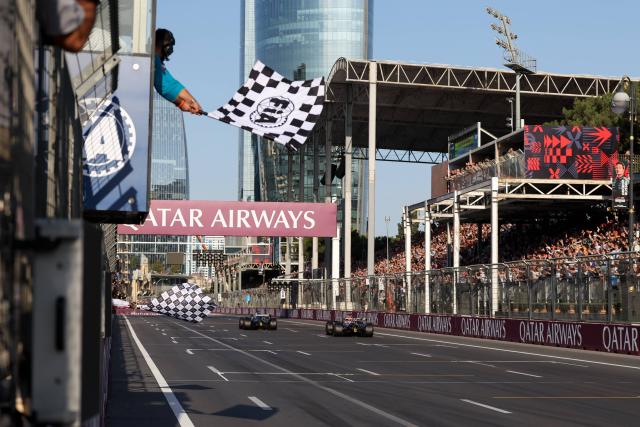 (260927) -- BAKU, Sept. 27, 2026 (Xinhua) -- Mercedes' driver George Russell (L) of Britain and  Red Bull Racing's driver Max Verstappen of the Netherlands cross the finish line during the Formula One Azerbaijan Grand Prix at the Baku City Circuit in Baku, on Sept. 26, 2026. (Photo by Qian Jun/Xinhua)