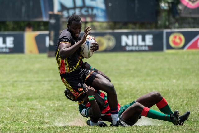 (260927) -- KAMPALA, Sept. 27, 2026 (Xinhua) -- Karim Arinaitwe (top) of Uganda competes for the ball during the 2026 Rugby Africa Men's Sevens Series match between Uganda and Senegal at Kyadondo Rugby Grounds in Kampala, Uganda, Sept. 26, 2026. (Photo by Hajarah Nalwadda/Xinhua)