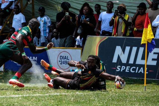 (260927) -- KAMPALA, Sept. 27, 2026 (Xinhua) -- Alex Aturinda (front R) of Uganda scores a try during the 2026 Rugby Africa Men's Sevens Series match between Uganda and Senegal at Kyadondo Rugby Grounds in Kampala, Uganda, Sept. 26, 2026. (Photo by Hajarah Nalwadda/Xinhua)