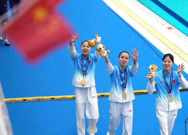 (260927) -- HAMAMATSU, Sept. 27, 2026 (Xinhua) -- Gold medalists Lin Yanjun, Xu Huiyan, Lin Yanhan (from L to R) of China greet the spectators after the victory ceremony for the duet of artistic swimming at the 20th Asian Games Aichi-Nagoya 2026 in Hamamatsu of Shizuoka Prefecture, Japan, Sept. 27, 2026. (Xinhua/Zhou Mi)