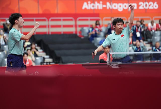 (260927) -- TOYOTA, Sept. 27, 2026 (Xinhua) -- Huang Youzheng /Lin Shidong  (R) of China celebrates during the men's doubles semifinal table tennis match between Huang Youzheng/Lin Shidong of China and Matsushima Sora/Togami Shunsuke of Japan at the 20th Asian Games Aichi-Nagoya 2026 in Toyota of Aichi Prefecture, Japan, Sept. 27, 2026. (Xinhua/Cheong Kam Ka)