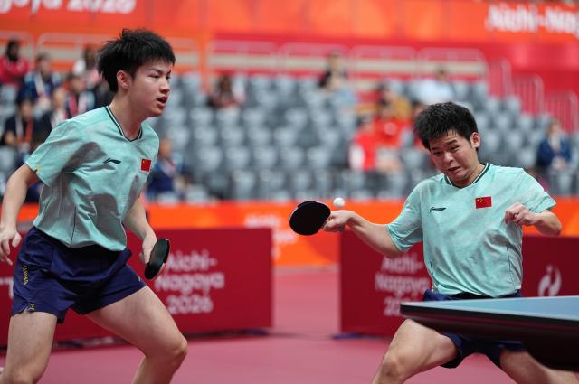 (260927) -- TOYOTA, Sept. 27, 2026 (Xinhua) -- Huang Youzheng (L)/Lin Shidong of China compete during the men's doubles semifinal table tennis match between Huang Youzheng/Lin Shidong of China and Matsushima Sora/Togami Shunsuke of Japan at the 20th Asian Games Aichi-Nagoya 2026 in Toyota of Aichi Prefecture, Japan, Sept. 27, 2026. (Xinhua/Cheong Kam Ka)