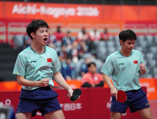 (260927) -- TOYOTA, Sept. 27, 2026 (Xinhua) -- Huang Youzheng (L)/Lin Shidong of China react during the men's doubles semifinal table tennis match between Huang Youzheng/Lin Shidong of China and Matsushima Sora/Togami Shunsuke of Japan at the 20th Asian Games Aichi-Nagoya 2026 in Toyota of Aichi Prefecture, Japan, Sept. 27, 2026. (Xinhua/Cheong Kam Ka)