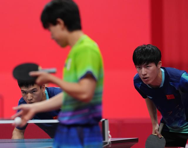 (260927) -- TOYOTA, Sept. 27, 2026 (Xinhua) -- Xiang Peng (L)/Wen Ruibo (R) of China react during the men's doubles semifinal table tennis match between Xiang Peng/Wen Ruibo of China and Harimoto Tomokazu/Shinozuka Hiroto of Japan at the 20th Asian Games Aichi-Nagoya 2026 in Toyota of Aichi Prefecture, Japan, Sept. 27, 2026. (Xinhua/Cheong Kam Ka)