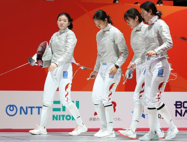 (260927) -- TOKONAME, Sept. 27, 2026 (Xinhua) -- Pan Qimiao, Rao Xueyi, Wei Jiayi and Zhang Xinyi (from L to R) of China react after the women's sabre team semifinal match of fencing between China and South Korea at the 20th Asian Games Aichi-Nagoya 2026 in Tokoname of Aichi Prefecture, Japan, Sept. 27, 2026. (Xinhua/Yao Qilin)