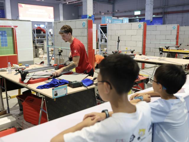 (260927) -- SHANGHAI, Sept. 27, 2026 (Xinhua) -- A competitor takes part in the wall and floor tiling competition during the 48th WorldSkills Competition in Shanghai, east China, Sept. 26, 2026. Competitors from across the world showcased their skills in the competitions of construction and building technology sector, such as bricklaying, concrete construction and cabinetmaking, at the 48th WorldSkills Competition in Shanghai. (Xinhua/Liu Ying)