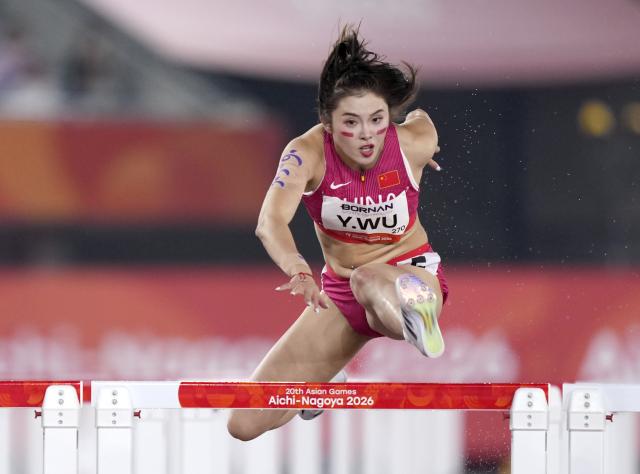 (260927) -- NAGOYA, Sept. 27, 2026 (Xinhua) -- Wu Yanni of China competes during the women's 100m hurdles final of Athletics at the 20th Asian Games Aichi-Nagoya 2026 in Nagoya, Japan, Sept. 27, 2026. (Xinhua/Lui Siu Wai)