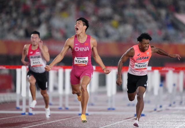 (260927) -- NAGOYA, Sept. 27, 2026 (Xinhua) -- Chen Yuanjiang (C) of China reacts after the men's 110m hurdles final of Athletics at the 20th Asian Games Aichi-Nagoya 2026 in Nagoya, Japan, Sept. 27, 2026. (Xinhua/Lui Siu Wai)