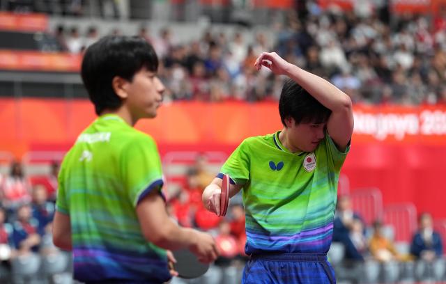 (260927) -- TOYOTA, Sept. 27, 2026 (Xinhua) -- Harimoto Tomokazu (R)/Shinozuka Hiroto react during the men's doubles final table tennis match between Lin Shidong/Huang Youzheng of China and Harimoto Tomokazu/Shinozuka Hiroto of Japan at the 20th Asian Games Aichi-Nagoya 2026 in Toyota of Aichi Prefecture, Japan, Sept. 27, 2026. (Photo by Cheong Kam Ka/Xinhua)