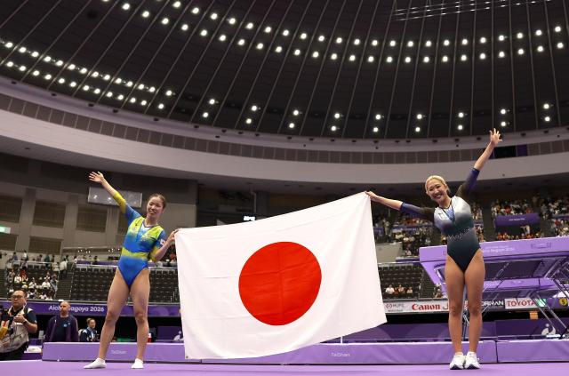 (260927) -- NAGOYA, Sept. 27, 2026 (Xinhua) -- Mori Hikaru (R) and Uyama Megu of Japan celebrate after the women's super final match of Trampoline Gymnastics at the 20th Asian Games Aichi-Nagoya 2026 in Nagoya, Japan, Sept. 27, 2026. (Xinhua/Xu Yanan)