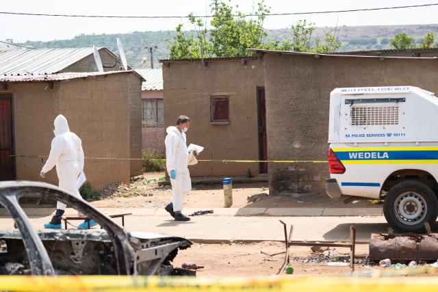 (260927) -- WEDELA, Sept. 27, 2026 (Xinhua) -- People work at the scene of a shooting incident in the mining township of Wedela in Gauteng Province, South Africa, Sept. 27, 2026. Seventeen people were killed Saturday night in a bar shooting in the mining township of Wedela in South Africa, local media reported on Sunday. (Photo by Rumana Akoob/Xinhua)